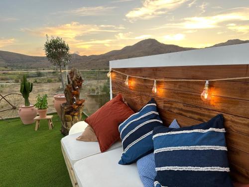 a couch with pillows on a patio with a view at Hotel Portmán in Portman