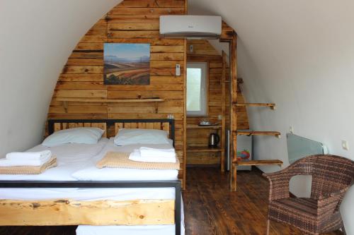 a bedroom with a bed with a wooden wall at Glamping Eco Valley in Shahumyan