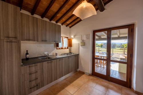 a kitchen with a sink and a counter with a window at Tenuta La Chiusa in Portoferraio