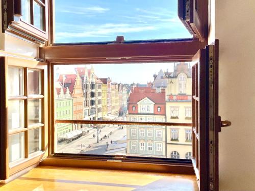 an open window with a view of a city at Wroclaw Inn Apartments in Wrocław