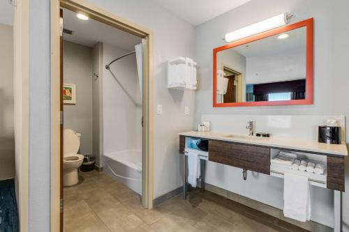 a bathroom with a sink and a toilet and a mirror at Hampton Inn & Suites Selma-San Antonio/Randolph AFB in Selma