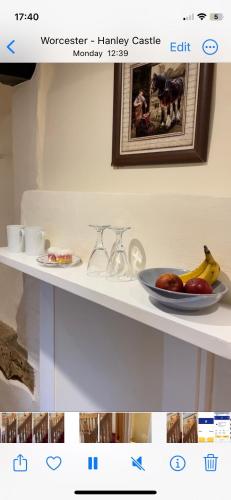 a white shelf with a plate of fruit on it at Gilberts End Farm in Great Malvern