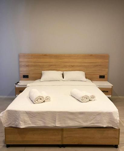 a large bed with two white towels on it at Elasu Bodrum in Bodrum City