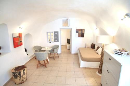 a small room with a white couch and a white table at Prime Suites in Oia