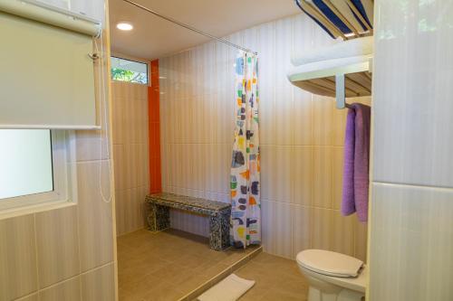 a bathroom with a toilet and a shower at Sutera Sanctuary Lodges At Manukan Island in Kota Kinabalu
