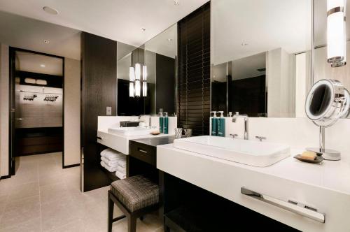 a bathroom with two sinks and a large mirror at Hilton Yokohama in Yokohama