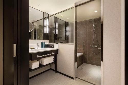 a bathroom with a sink and a shower at Hilton Yokohama in Yokohama