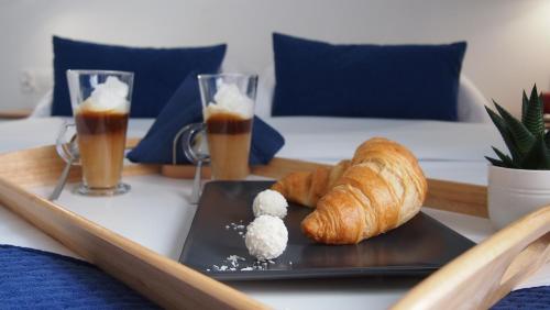 a table with two plates of bread and two glasses of beer at Mile Gdansk Airport & Parking Długoterminowy in Gdańsk