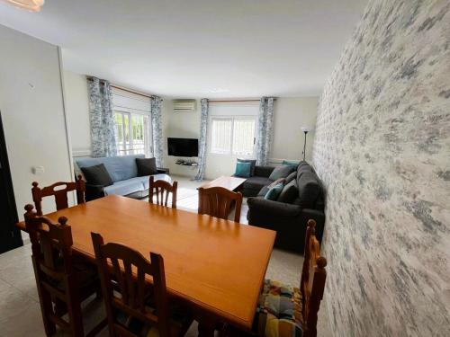 a living room with a table and a couch at Villa Preciosa in Les tres Cales