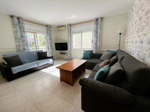 a living room with a couch and a table at Villa Preciosa in Les tres Cales