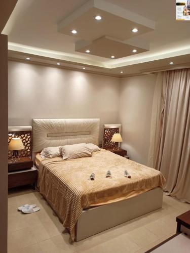 a bedroom with a large bed with two lamps at شقه اكثر روعه فيو بحر مباشر in Alexandria