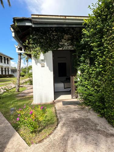 a small white building with an open door at Amaluna Resorts in Negombo