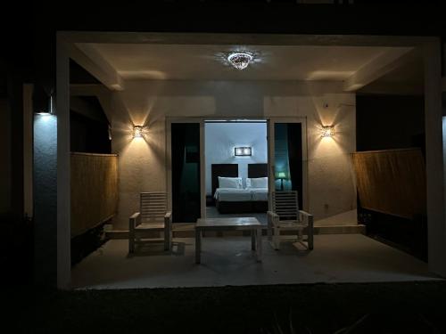 a room with a bed and two chairs and a table at Amaluna Resorts in Negombo
