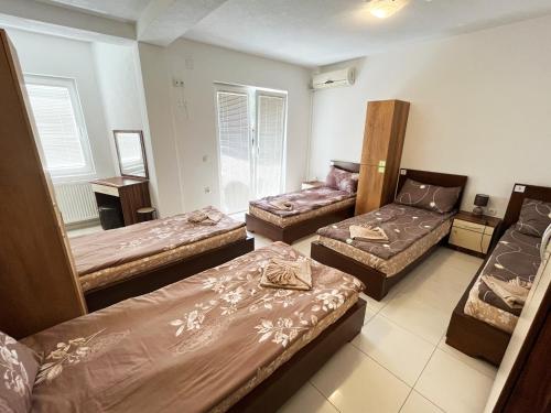 a room with three beds and a couch at Majap hostel in Ohrid