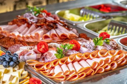 a buffet with many different types of food on display at Szarvaskút Hotel in Zirc