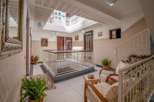 a living room with a staircase and a balcony at Riad HAFSSA & Spa in Marrakesh
