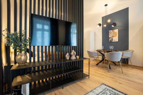 a living room with a television and a dining room at 2-rooms apartment 10 min away from city center in Vienna