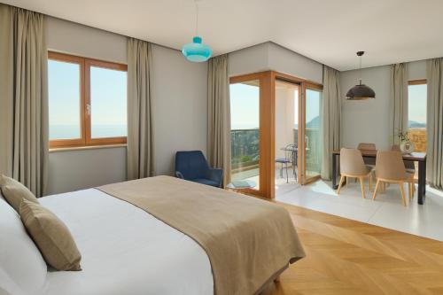 a bedroom with a bed and a table with chairs at Palace Natali in Dubrovnik