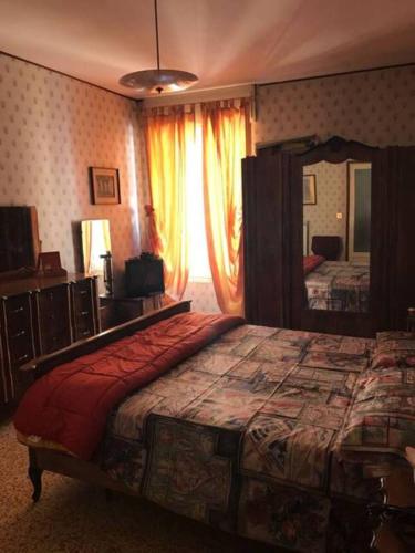 a bedroom with a large bed and a large mirror at La Benny delle Meraviglie in Salò