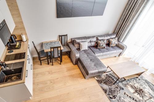 a living room with a couch and a table at RentPlanet - Apartamenty Zarembowicza II in Wrocław