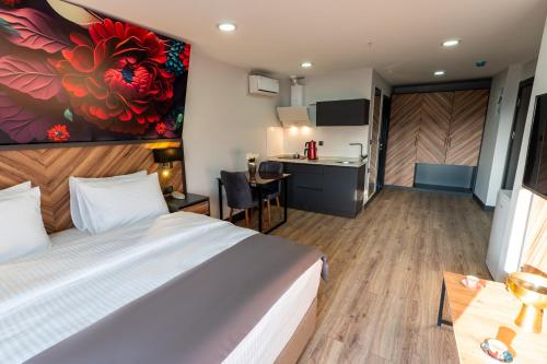 a hotel room with a bed and a kitchen at Yusufhan Suites in Trabzon