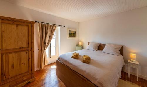 a bedroom with a large bed with two towels on it at Rue du Barri in Cordes-sur-Ciel