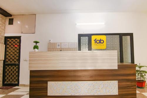 an office with a reception desk with a job sign on the wall at FabHotel Ace in Ludhiana