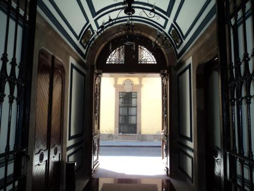 an open hallway with an archway in a building at Hotel San Francisco in San Luis Potosí