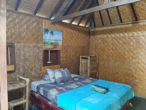 a bedroom with a bed in a room at New Taman Sari Homestay in Pawenang
