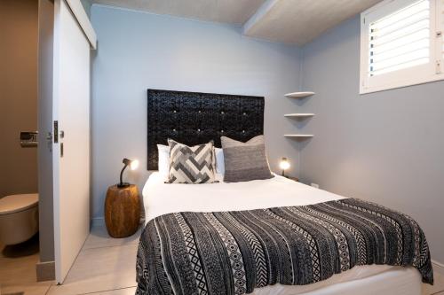 a bedroom with a large bed and a window at Gorgeous Coral Point Sibaya in Umdloti