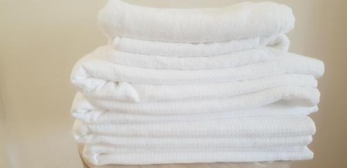 uma pilha de toalhas brancas empilhadas umas em cima das outras em City Center Cosy Three Beds em Luxemburgo