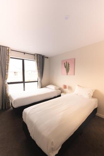 a hotel room with two beds and a window at Crescent Moon in Lake Tekapo