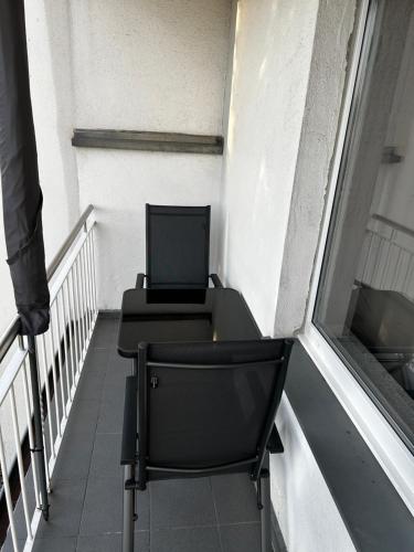 a laptop computer sitting on a table on a balcony at ERSTAY - bis zu 5 Personen I Balkon in Marl