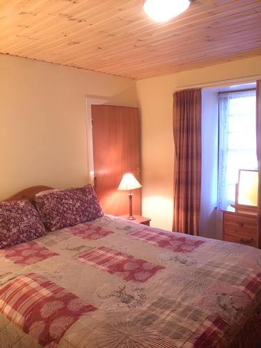 a bedroom with a bed and a window at Pond Cottage in Covington