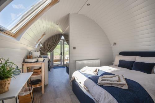 a small bedroom with a bed and a window at Cedar in Bridport