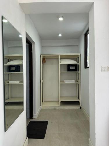 a walk in closet with shelves and a mirror at Amaluna Resorts in Negombo