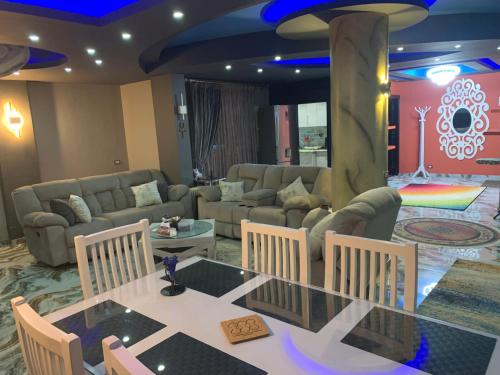 a living room with a couch and a table and chairs at Ismailia in Ismailia