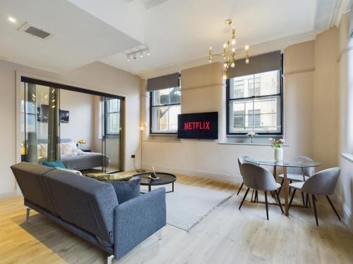 a living room with a couch and a table at Classy 2bedroom City Centre Apt in Manchester