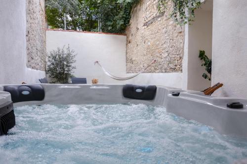 a bath tub filled with water in a bathroom at La Romance à Bulles en Hyper Centre in La Rochelle