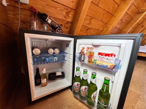 an open refrigerator filled with lots of drinks at Thethi Villas in Theth