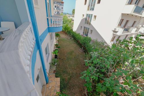 an alley between two buildings with plants at Hotel Divo Palace in Ksamil
