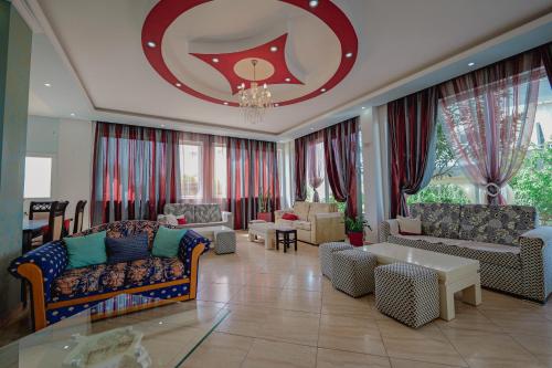a large living room with couches and a chandelier at Hotel Divo Palace in Ksamil