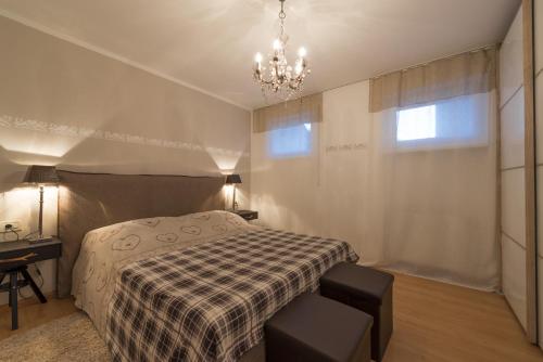 a bedroom with a bed and a chandelier at Apartment Sofia in Mühlbach