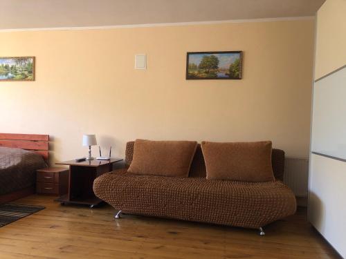 a living room with a couch and a bed at Apartment complex in Sumy