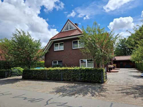 a red brick house with a triangular roof at Ferienwohnung Lerchi's Ankerplatz in Barßel