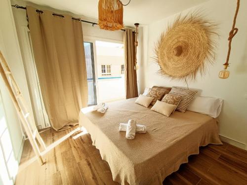a bedroom with a bed with two towels on it at Chakra House Fuerteventura in Corralejo