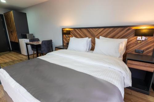a large white bed in a hotel room at Yusufhan Suites in Trabzon