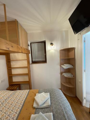 a bedroom with a bed and a tv and bunk beds at T2 avec terrasse fitness et bien-être - Le Diamant in Villard-de-Lans