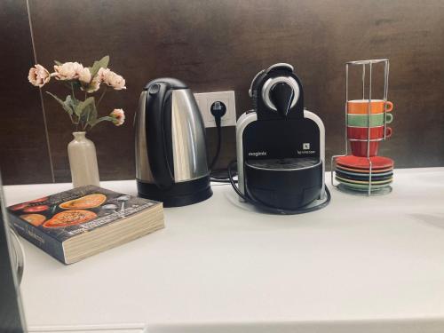 a counter top with a coffee maker and a blender at Apartament lovely space in Rzeszów