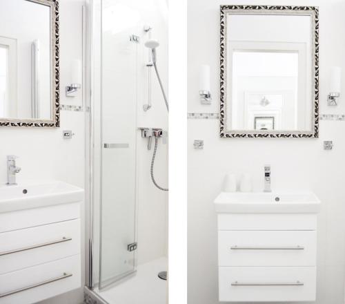 a bathroom with a shower and a sink and a mirror at Bellevue C14 in Großenbrode